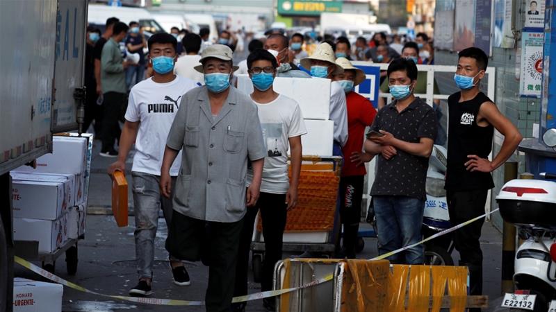 Masked people in Beijing await testing Xinfadi Market