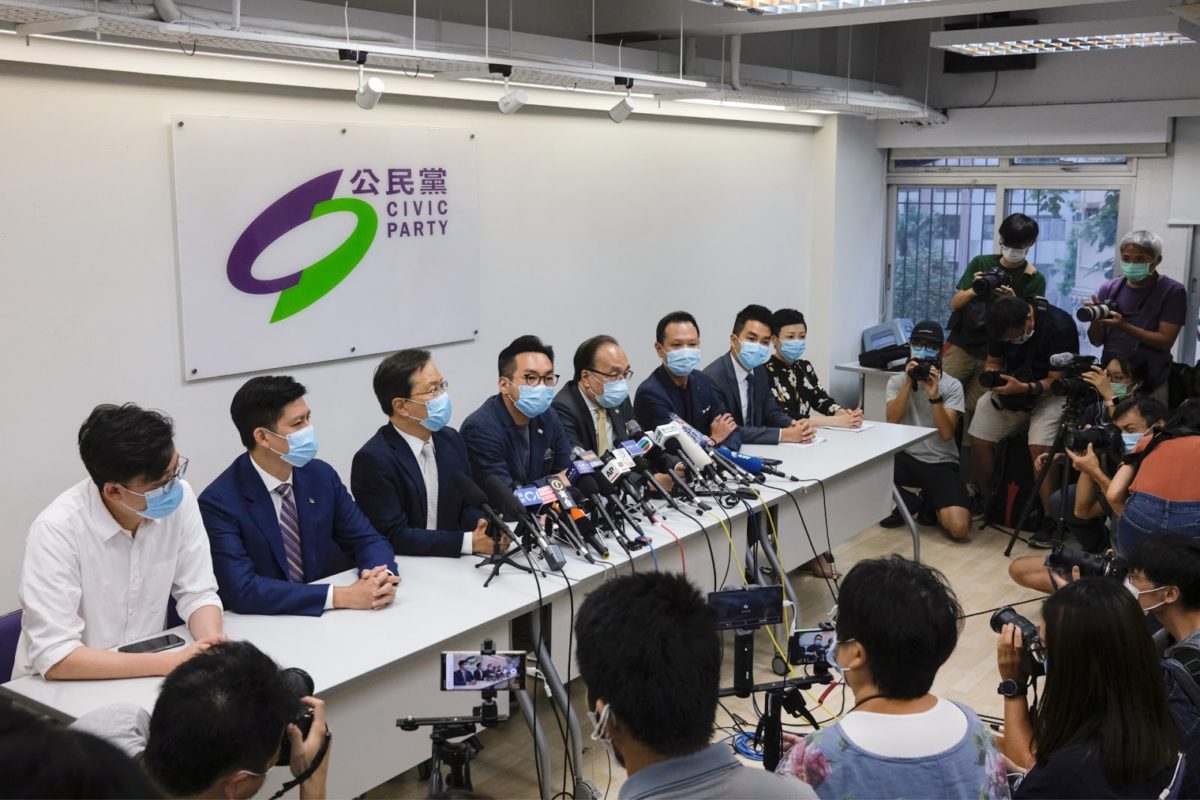 members of the hong kong civic party holds a news conference surrounded by reporters