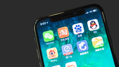 an iphone with the logo icons of popular chinese apps