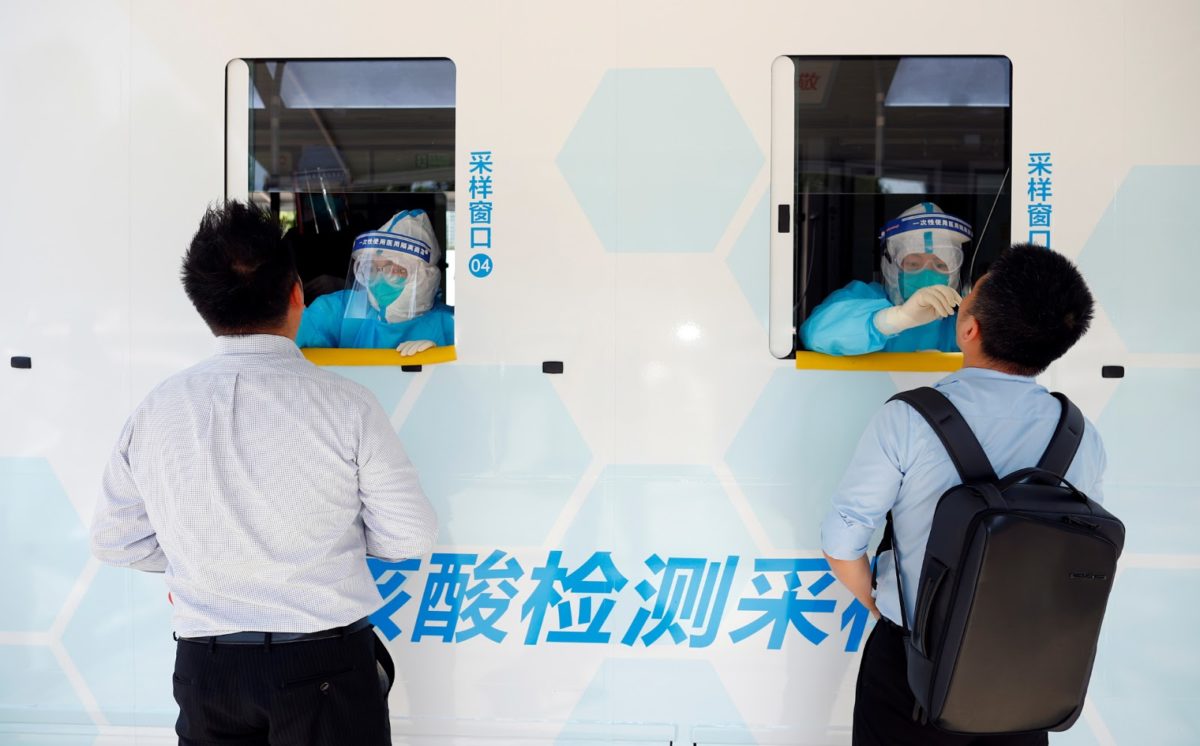 two people in beijing get tested for the coronavirus (covid-19) at a mobile testing vehicle