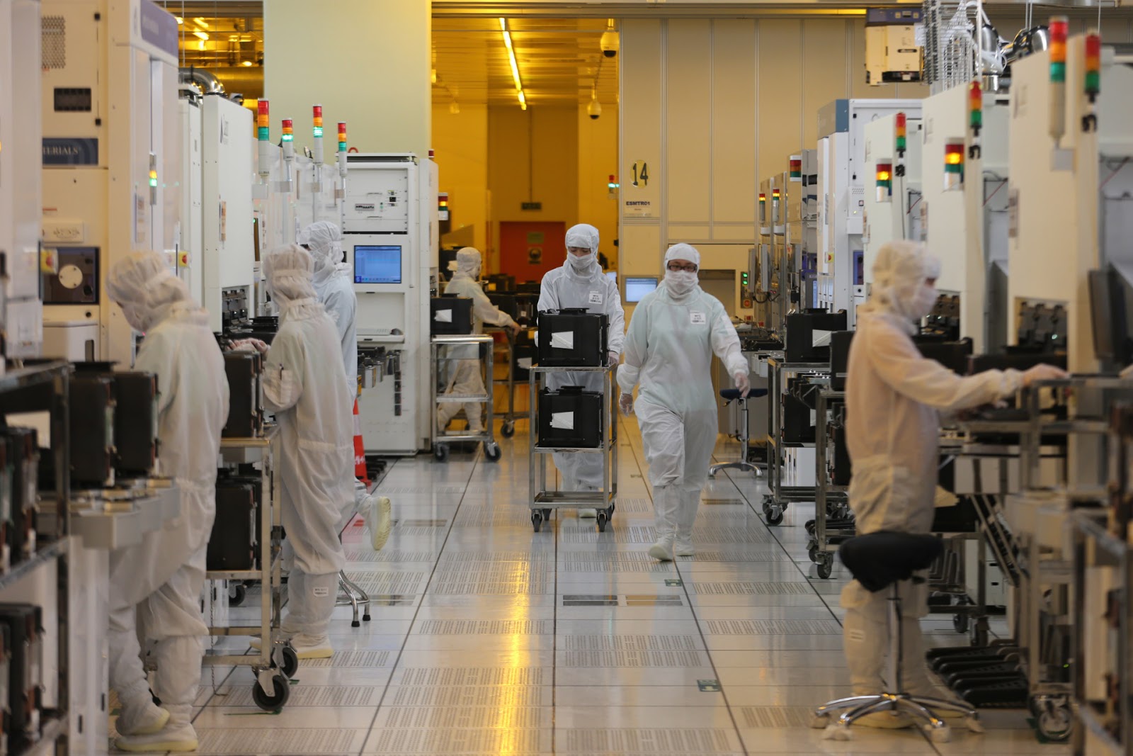 workers wearing dust-protective gowns in a clean room in beijing for semiconductor manufacturer smic