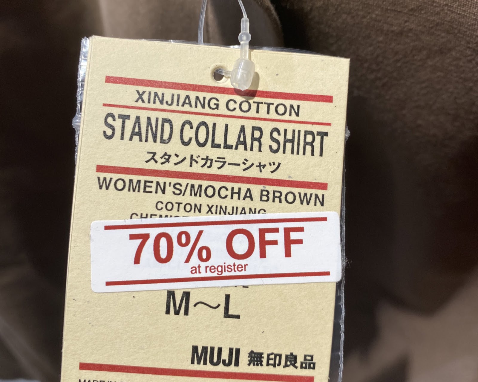 a tag of a muji standard collar shirt with the words "xinjiang cotton" on top