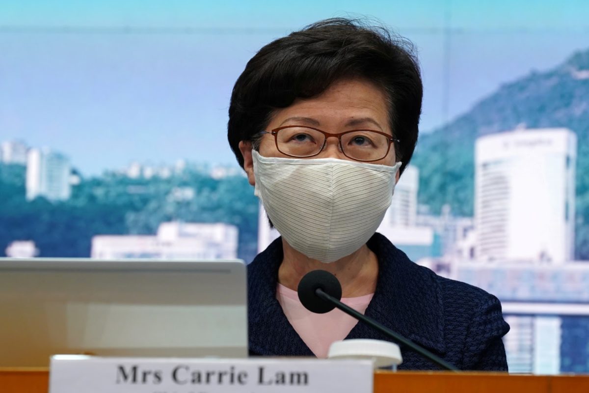 hong kong leader carrie lam at a news conference, wearing a face mask