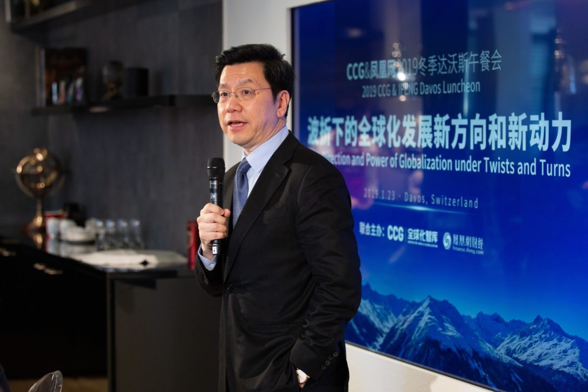 kaifu lee giving a talk at davos in 2019, standing and with a microphone in hand