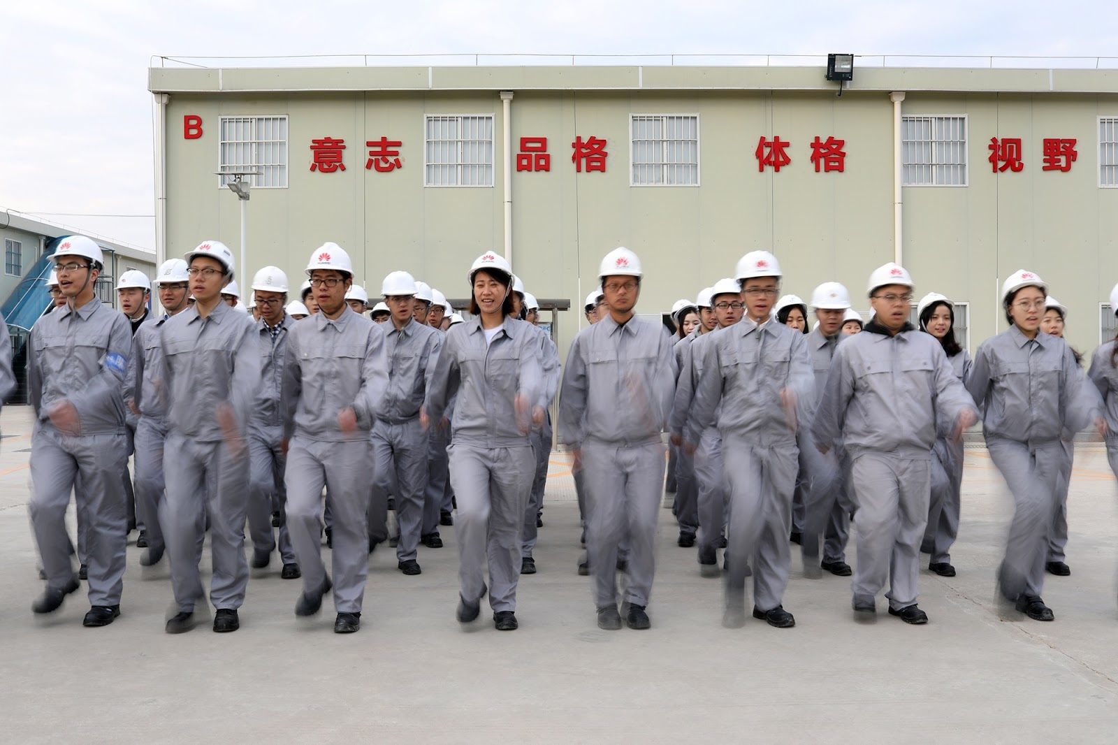 a group of Huawei employees doing exercises