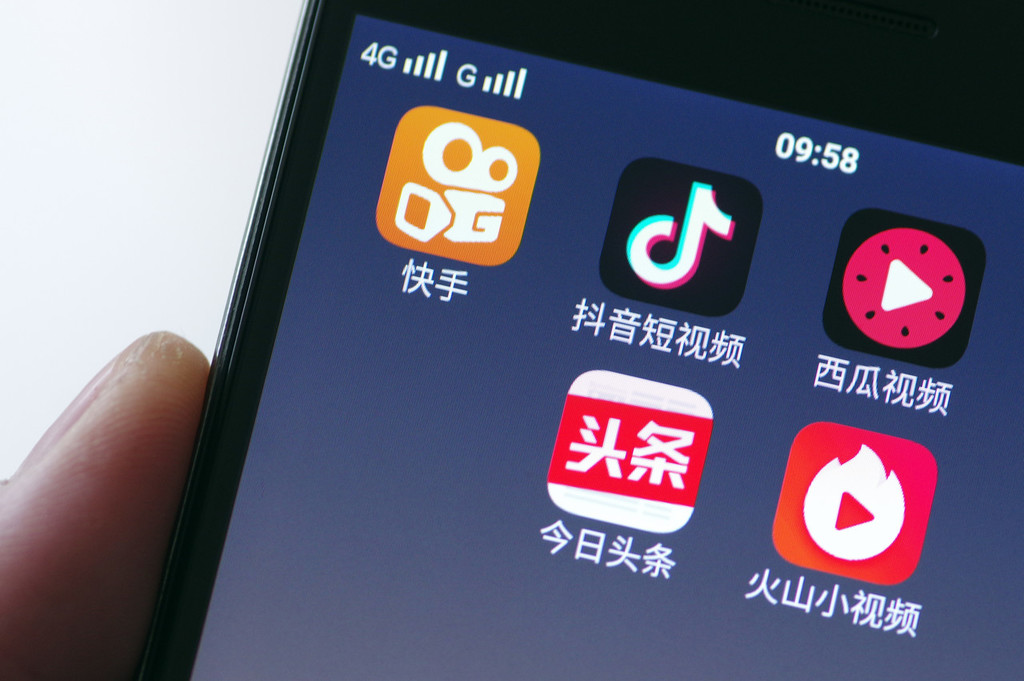 A cell phone displaying the shortcut icons for China's most popular short-form video apps, including Douyin and Kuaishou.