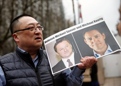Louis Huang holds a placard ccalling for China to release Canadian detainees Michael Spavor and Michael Kovrig outside a court hearing for Huawei Technologies Chief Financial Officer Meng Wanzhou at the B.C. Supreme Court in Vancouve
