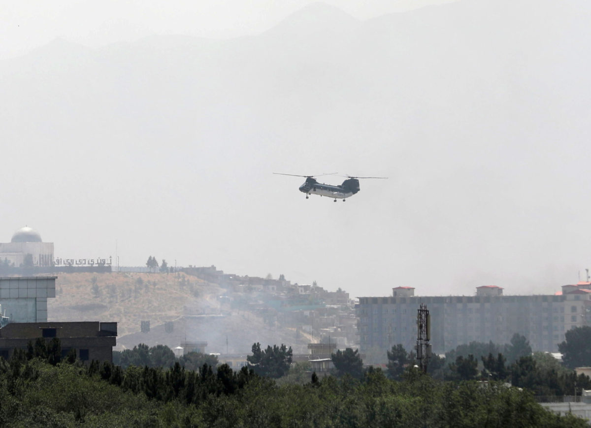 A U.S. military transport helicopter flies over Kabul