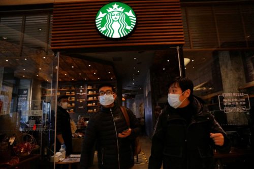 two people leaving a Starbucks store in Beijing