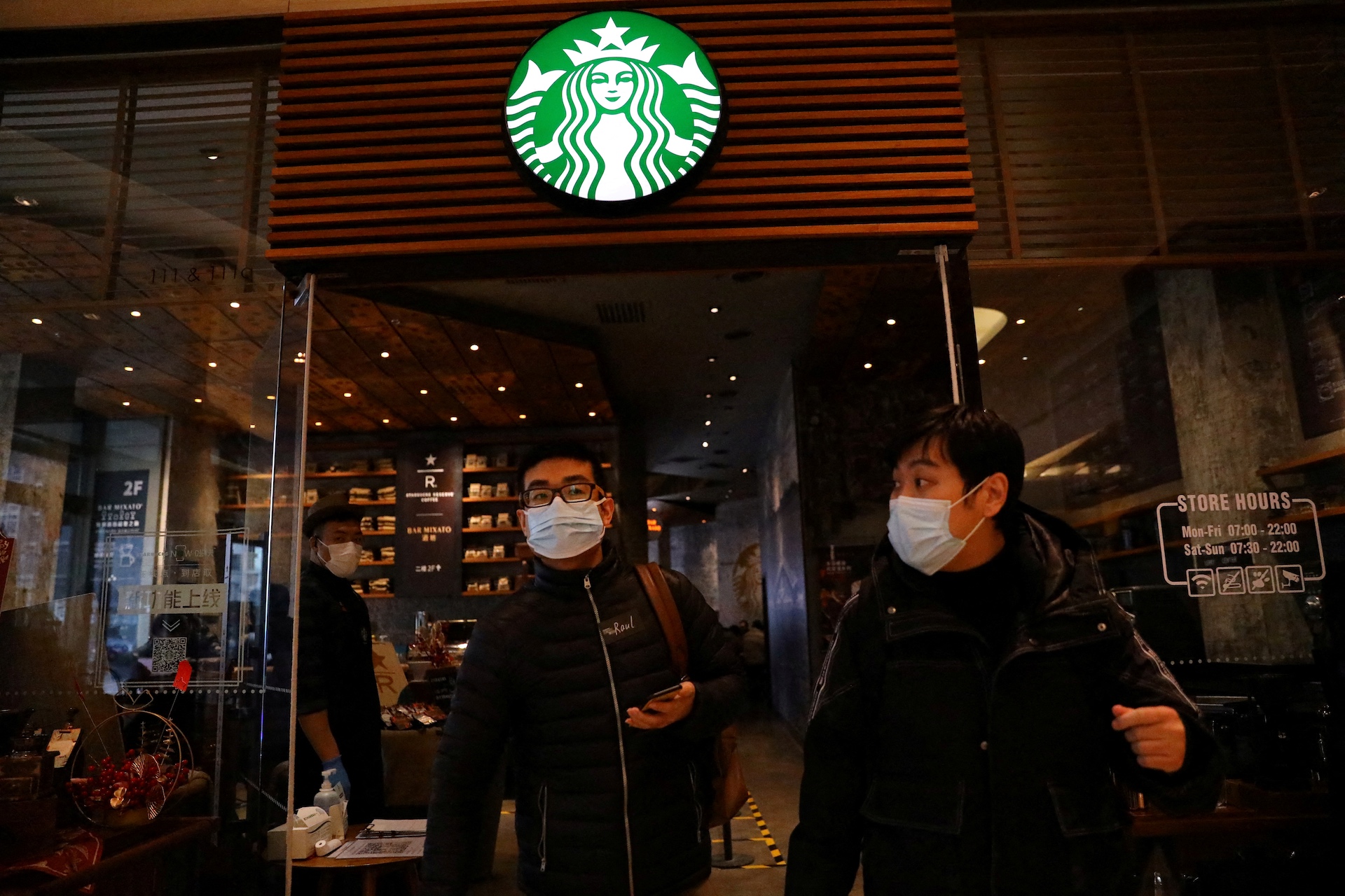 two people leaving a Starbucks store in Beijing